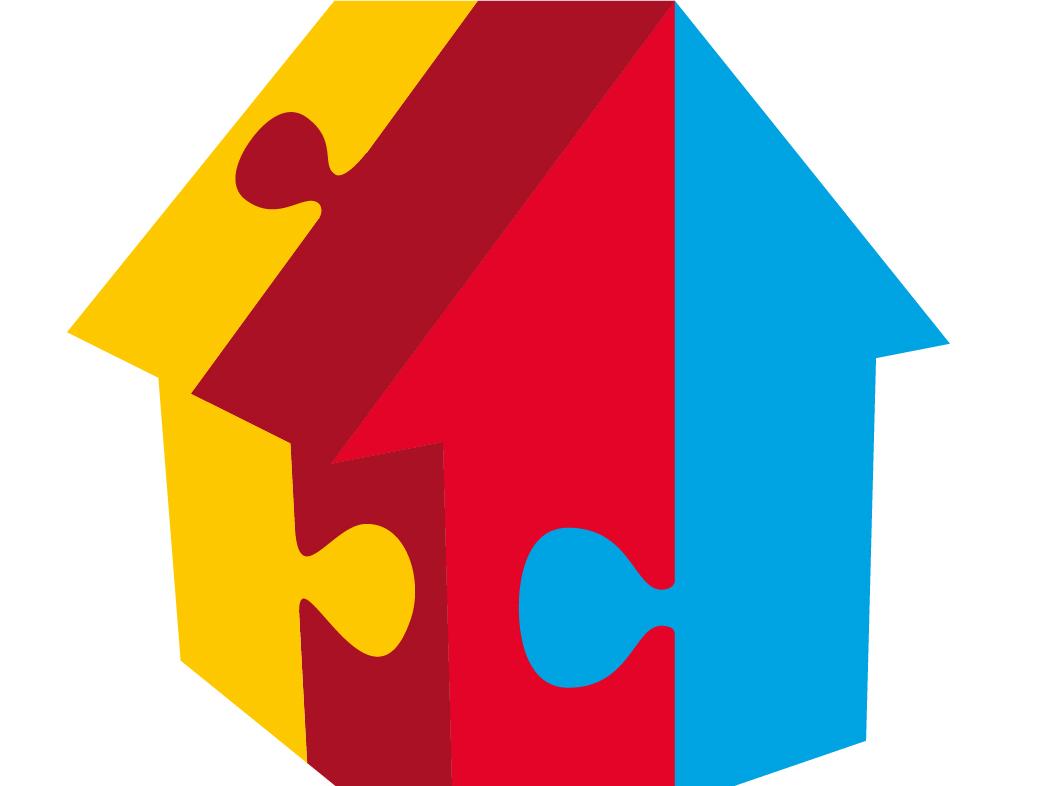 Das Bild zeigt ein Logo: Es besteht aus einer stilisierten Hausform, die aus drei farbigen Puzzleteilen zusammengesetzt ist – links gelb, in der Mitte rot, rechts blau. Darunter steht in grauer Schrift: